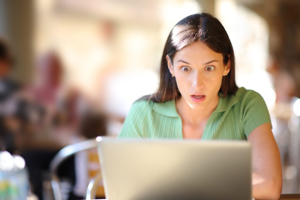 Beauty & Aesthetics 91345750 amazed woman checking laptop content in a bar